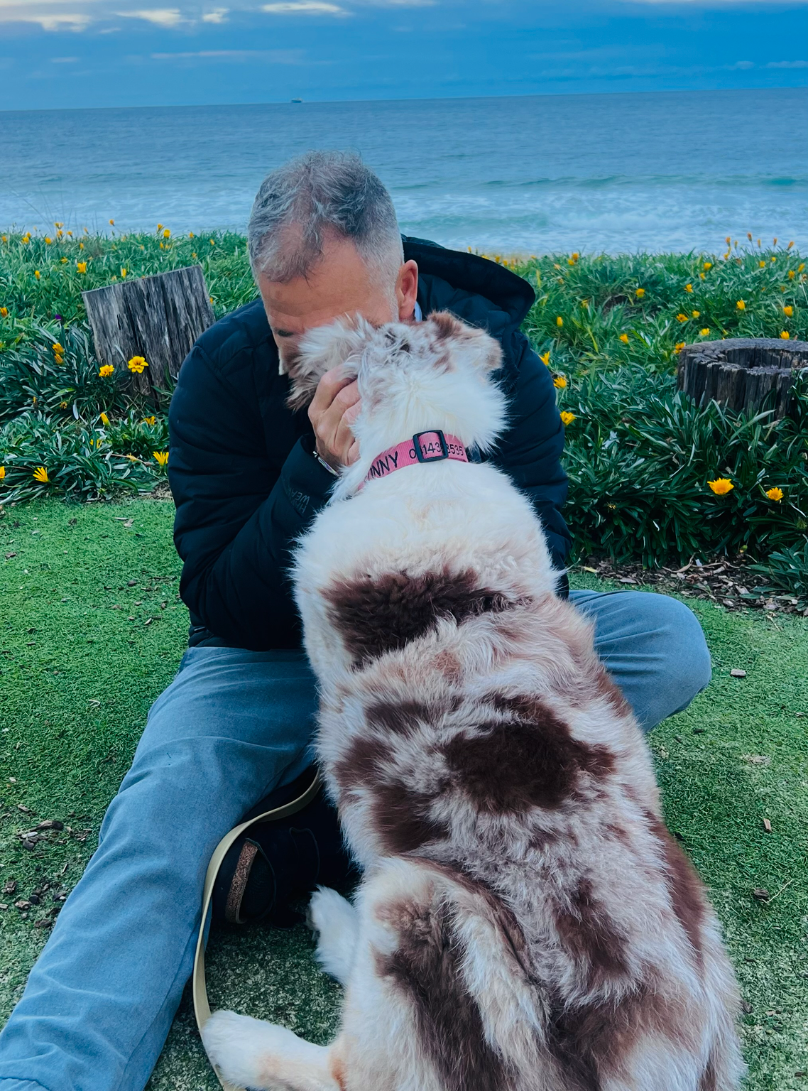 Paul embracing Sunny by the ocean.