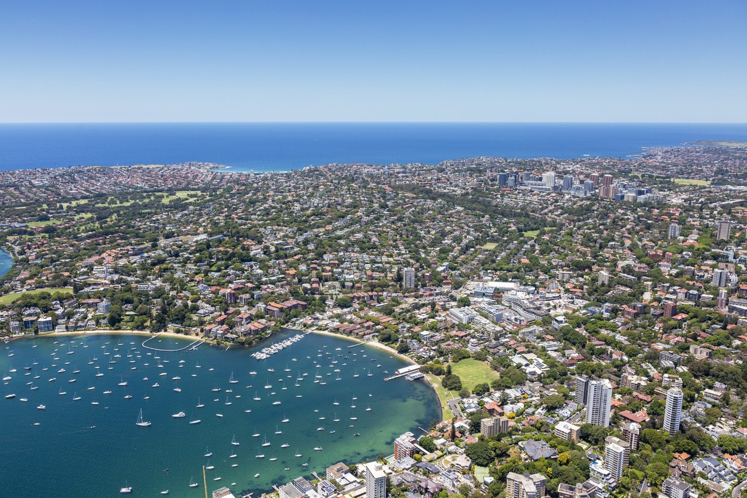 Harbourside neighbourhoods, boats and the coastline viewed from above